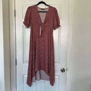 Deeper Red with diamond white pattern. Long flown dress. Low neckline with tie